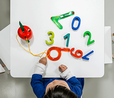 A child playing with number figures
