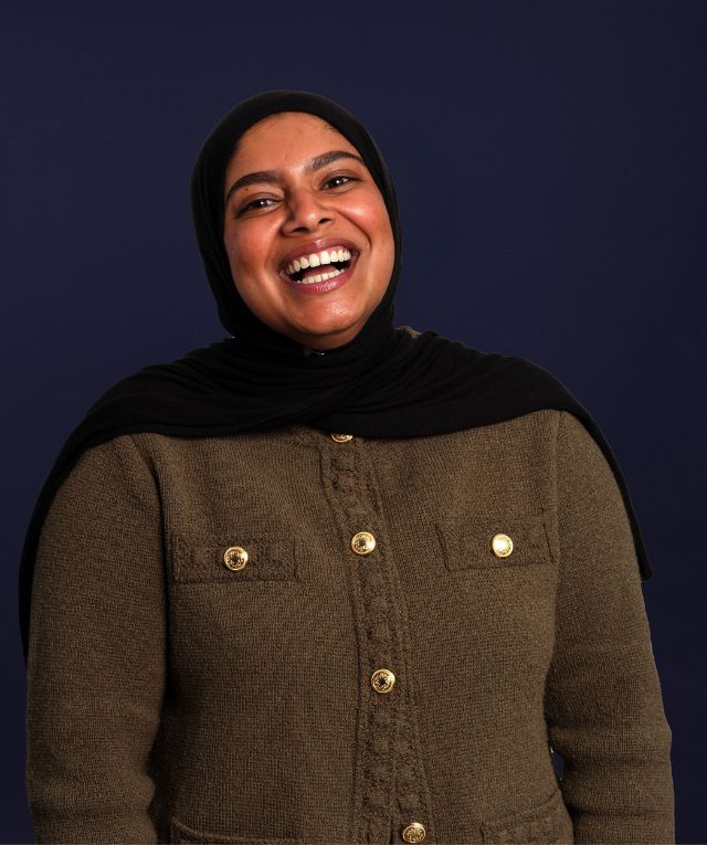 A woman in a headscarf smiling