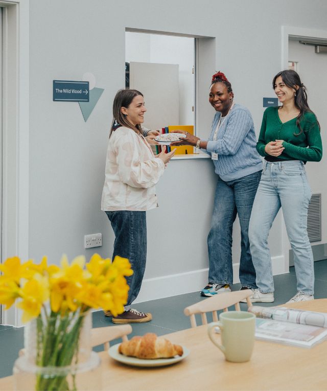Three women standing in a nursery cafe area