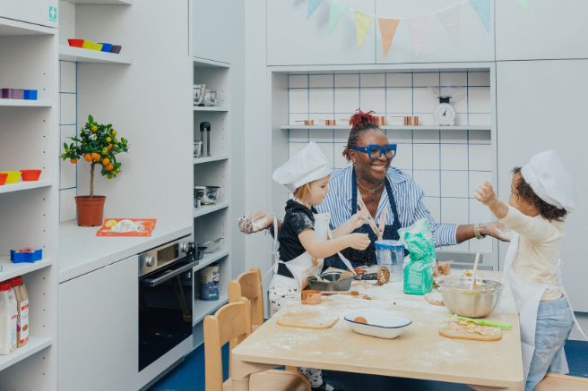 An educator and child cooking in a nursery atelier