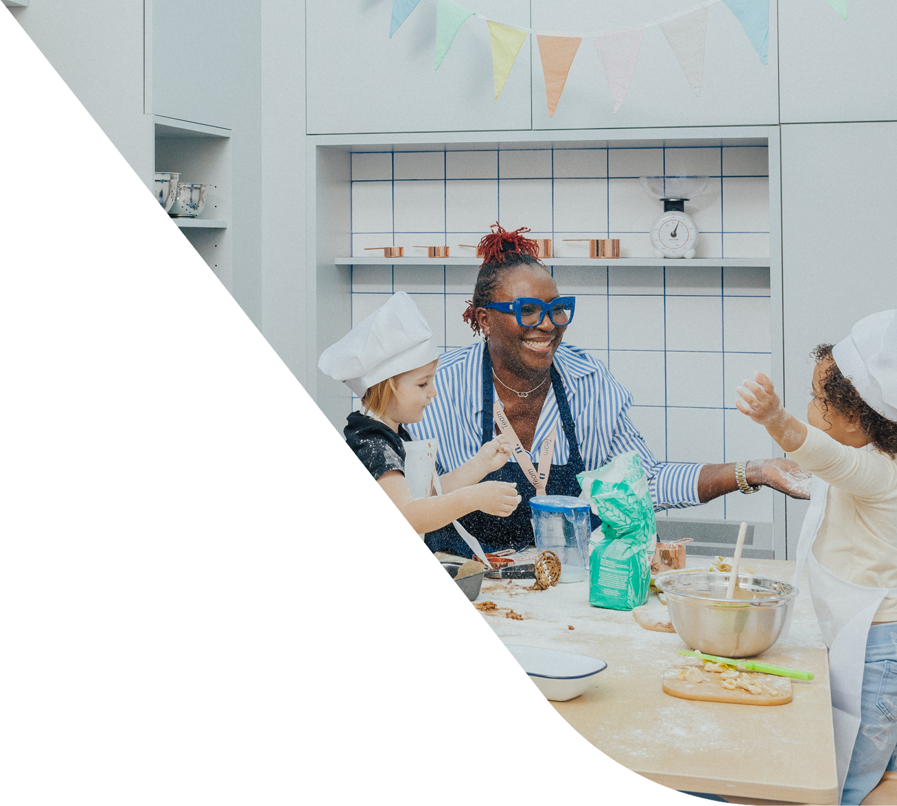 An educator and two children playing in a nursery atelier